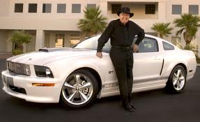 Carroll Shelby standing by Cobra